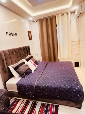 a bedroom with a bed with purple sheets and a rug at Dar Nahila Appartement Aéroport in Marrakech