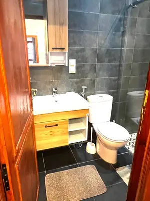 a bathroom with a toilet and a sink at Dar Nahila Appartement Aéroport in Marrakech