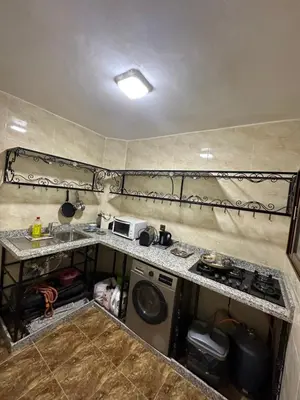 a small kitchen with a sink and a stove at 5 min Aéroport Appartement avec Terrasse et Grand Appartement in Marrakech