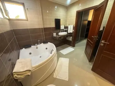 a bathroom with a large tub and a sink at Dar Zoubida in Marrakech