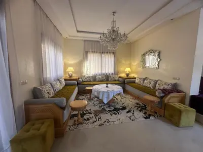 a living room with couches and a table at Dar Zoubida in Marrakech