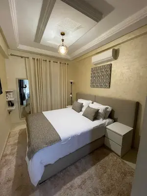 a bedroom with a large white bed with pillows at Élégant appart 2chambre, terrasses,proche Gueliz&parking in Marrakech