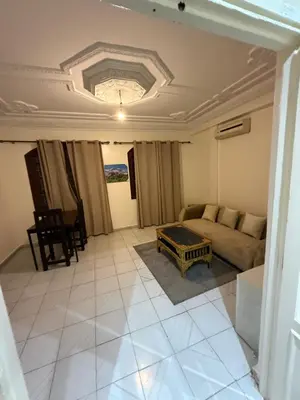 a living room with a couch and a table at Appartement Salia à Guéliz Marrakech in Marrakech