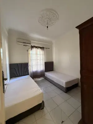 a bedroom with two beds and a window at Appartement Salia à Guéliz Marrakech in Marrakech