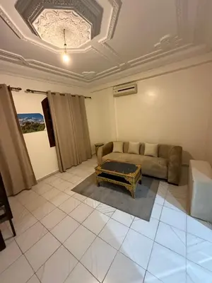 a living room with a couch and a table at Appartement Salia à Guéliz Marrakech in Marrakech