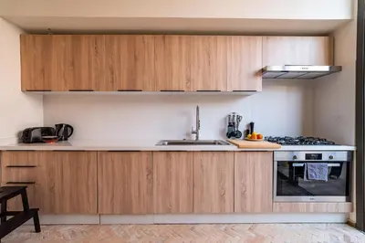 a kitchen with wooden cabinets and a sink at Villa 61 in Marrakech