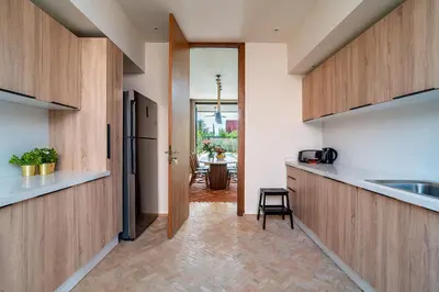 a kitchen with wooden cabinets and a counter top at Villa 61 in Marrakech