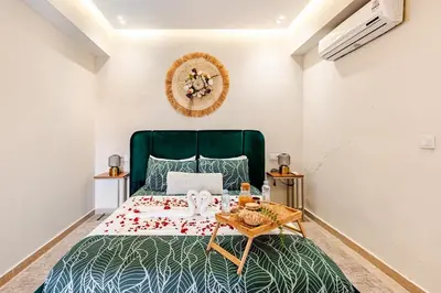 a bedroom with a green bed and a table at la cocon paisible de Marrakech in Marrakech
