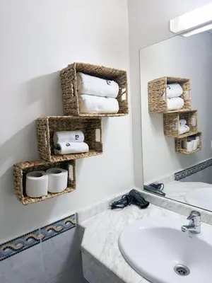 a bathroom with a sink and a mirror and towels at Ambre in Marrakech