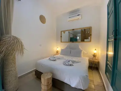 a bedroom with a bed with two towels on it at Riad Dar Khalti Privatisation in Marrakech