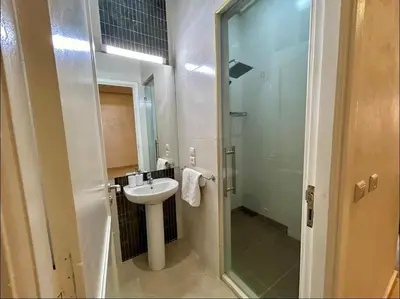 a small bathroom with a sink and a shower at Chic Appartement Marrakech in Marrakech