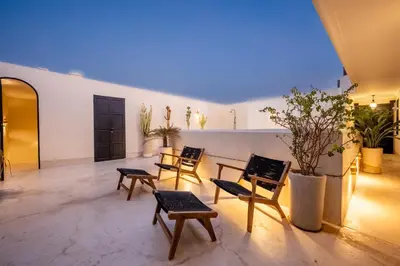 a room with chairs and tables in a building at Riad Nayl Medina & Spa in Marrakech