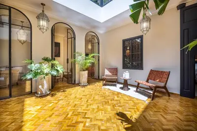 a living room with two chairs and a rug at Riad Nayl Medina & Spa in Marrakech