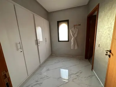 a hallway with a dress hanging on a wall at Villa à la palmeraie in Marrakech