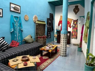 a living room with a couch and a table at Riad rajad Marrakech in Marrakech