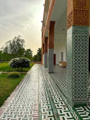 a tiled walkway next to a building with a building at Palais Bahida in Marrakech