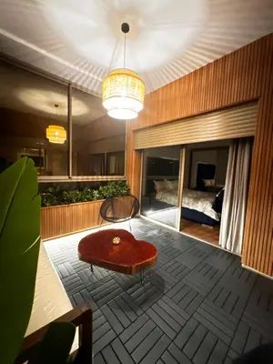 a living room with a table and a bed at Comfy space in Marrakech