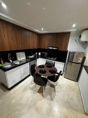 a kitchen with a table and chairs in a kitchen at Cossy Inn in Marrakech