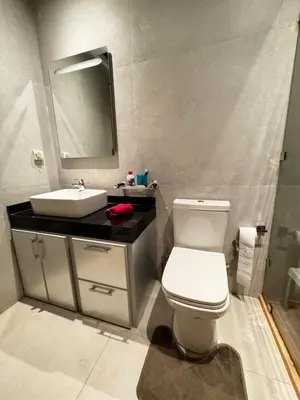 a bathroom with a white toilet and a sink at Cossy Inn in Marrakech