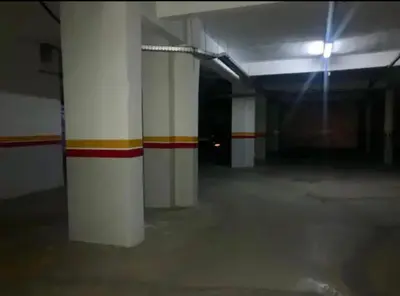 an empty parking garage with white and red stripes at Appartement 5 piscine sport in Marrakech