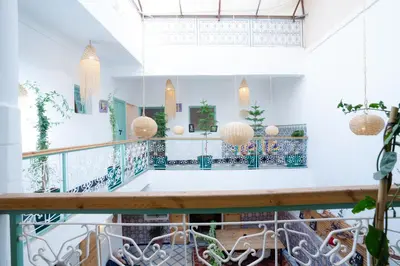 a room with a balcony with pendant lights at Riad Lkhlil in Marrakech