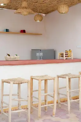 a counter with two stools at a bar at Riad Lkhlil in Marrakech