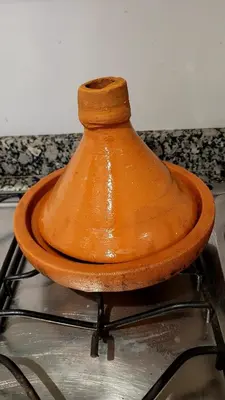 an orange vase sitting on top of a stove at le familial vous attend a L'Hivernage face Gare CTM in Marrakech