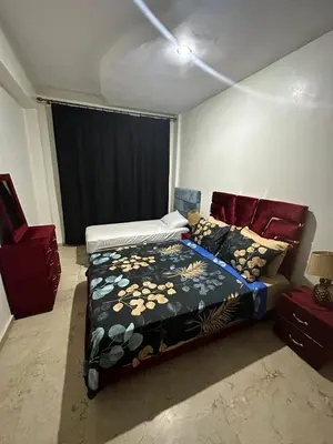 a bedroom with a bed and a couch in it at le familial vous attend a L'Hivernage face Gare CTM in Marrakech