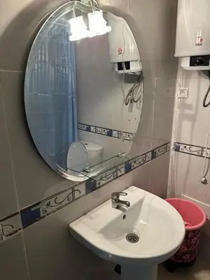 a bathroom with a sink and a mirror at le familial vous attend a L'Hivernage face Gare CTM in Marrakech