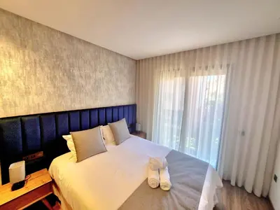 a bedroom with a bed with a pair of shoes on it at Stylish Marrakech getaway in Marrakech