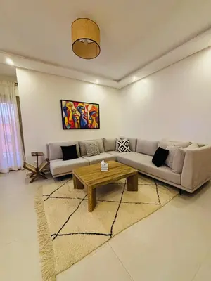 a living room with a couch and a coffee table at Charmant et central in Marrakech