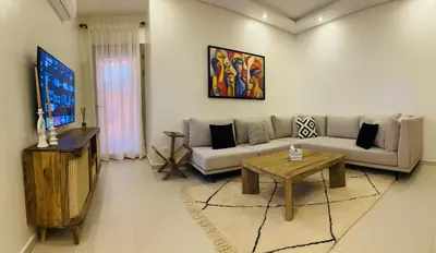 a living room with a couch and a table at Charmant et central in Marrakech