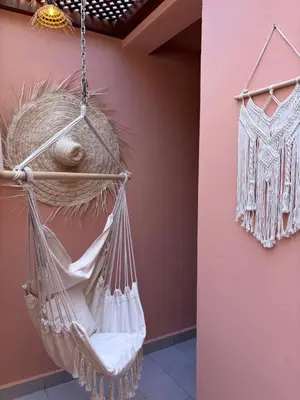a hammock hanging from a wall in a room at Charmant et central in Marrakech