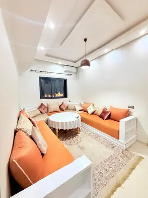 a living room with a couch and a table at Appart Abir2 N1 Confort Au Centre-ville in Marrakech