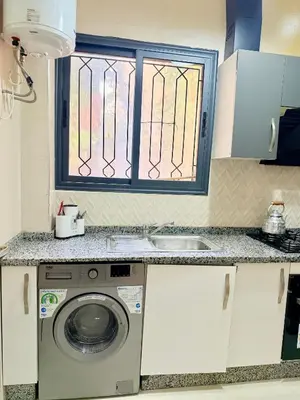 a kitchen with a washing machine and a sink at Appart Abir2 N1 Confort Au Centre-ville in Marrakech