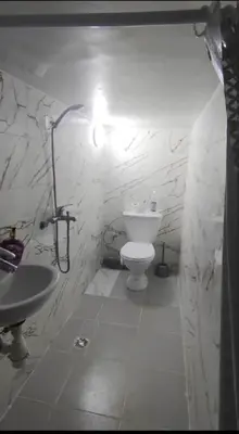 a white bathroom with a sink and a toilet at Chambre individuelle in Marrakech
