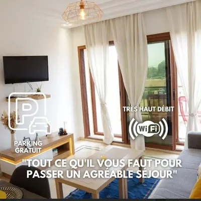 a living room with a couch and a window at Cosy cocon au coeur de Gueliz-Parking gratuit in Marrakech