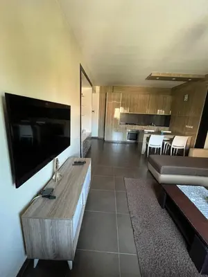a living room with a flat screen tv on a wall at Résidence ghita in Marrakech