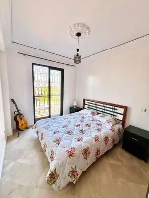 a bedroom with a bed and a guitar in it at Marrastay in Marrakech