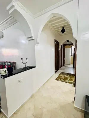 a hallway of a house with white walls and an archway at Marrastay in Marrakech