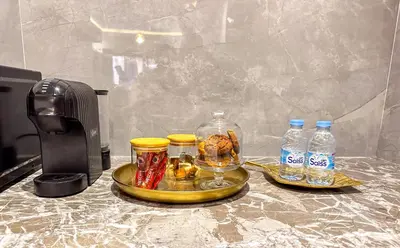 a table with a tray of food and bottles of water at Appartement cosy Marrakech in Marrakech