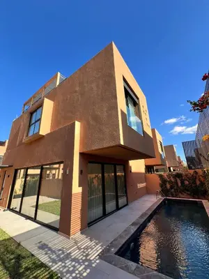 a house with a swimming pool in front of it at Villa Tagana in Marrakech