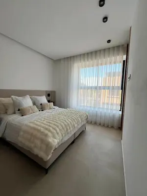 a bedroom with a large bed and a large window at Villa Tagana in Marrakech