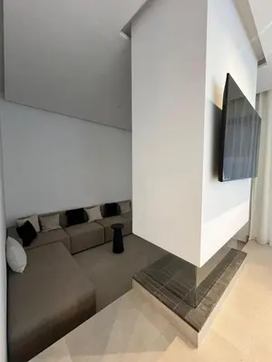 a living room with a couch and a flat screen tv at Villa Tagana in Marrakech