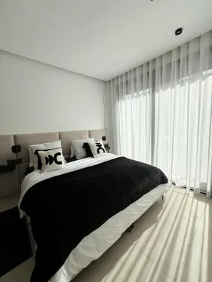 a bedroom with a large bed and a large window at Villa Tagana in Marrakech