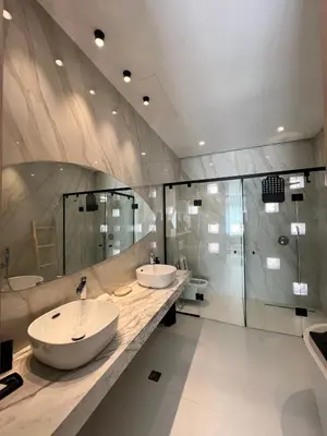 a bathroom with two sinks and a shower at Villa Tagana in Marrakech