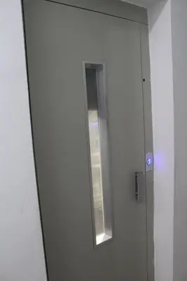 a bathroom door with a mirror and a window at beautiful appartement near airport in Marrakech