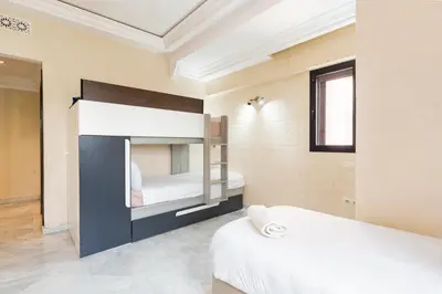 a bedroom with a bunk bed in a room at Exclusive Stay M-Avenue Marrakech in Marrakech