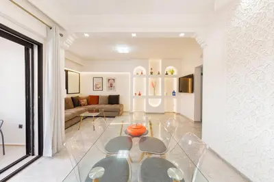 a living room with a glass table and a couch at Exclusive Stay M-Avenue Marrakech in Marrakech