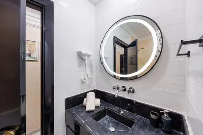 a bathroom with a sink and a mirror at Exclusive Stay M-Avenue Marrakech in Marrakech